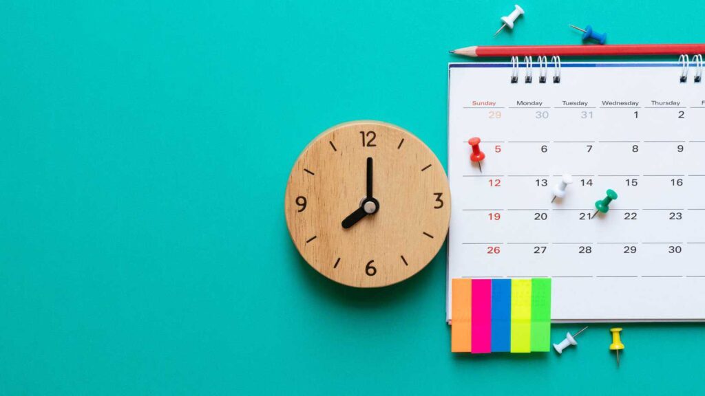 photo of a calendar and clock to signify decide on the dates and the duration - the very first step on how to plan a family staycation with toddlers.