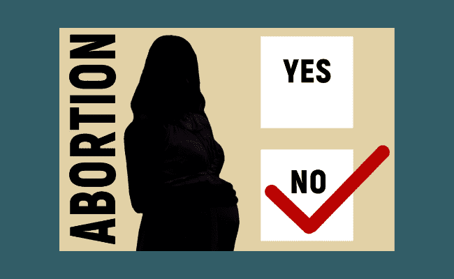 a prenant woman and a no abortion sign