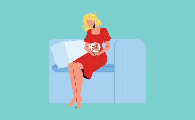 photo of a pregnant woman with an X sign on the fetus on the womb