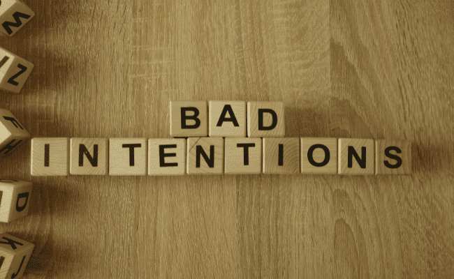 a photo of scrabble dice with the words bad intentions