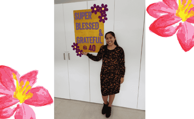a mother who is practicing modest dressing and celebrating her 40th birthday with a banner that says · super blessed & grateful @40"