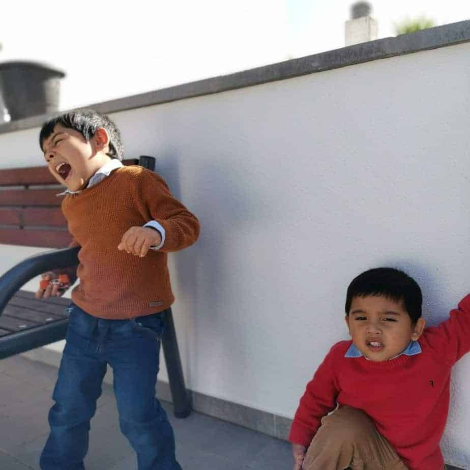 a photo of toddler boys feeling bored on a staycation