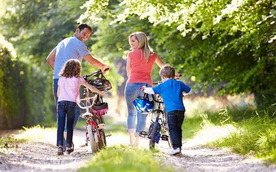 photo of a family with their bikes - another very affordable and fun family staycation ideas