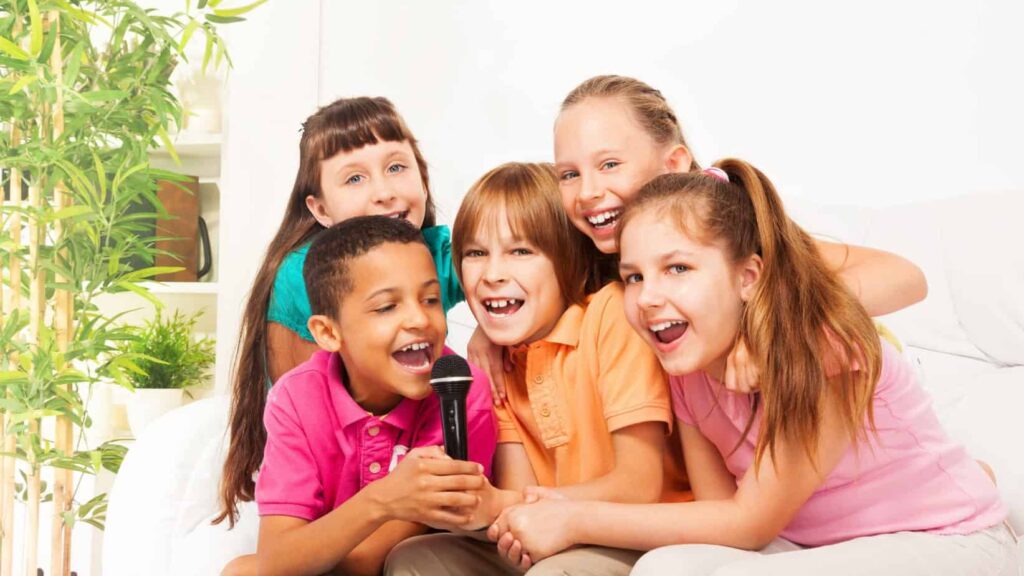 photo of kids sharing a microphone for some karaoke time - another memorable family staycation ideas.