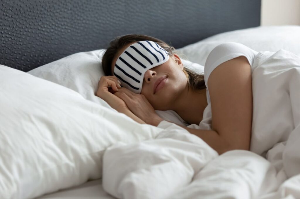 photo of a woman sleeping to signify sleep early as one of the New year resolutions of a Catholic mom.